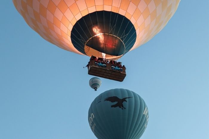 Colorful hot air balloons floating over Cappadocia's valleys at sunrise