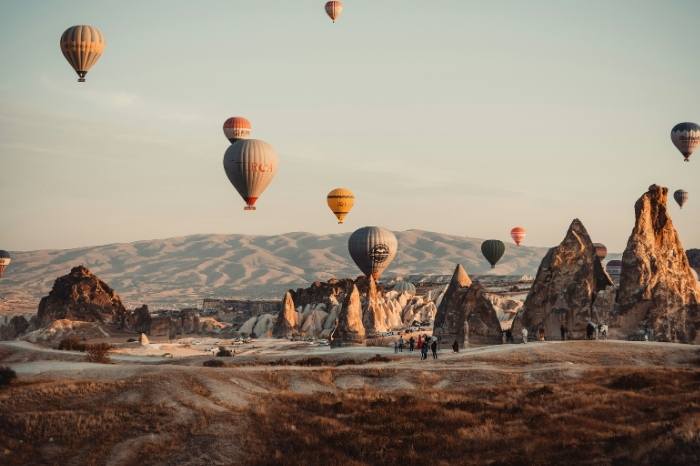 Collage showing Cappadocia's landscape during different seasons of the year