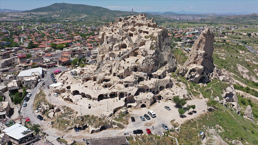 Uçhisar Castle overlooking the Cappadocia landscape at sunset